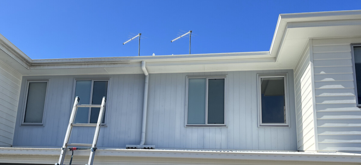 A house wash in progress with one side that is clean and one side that is dirty.